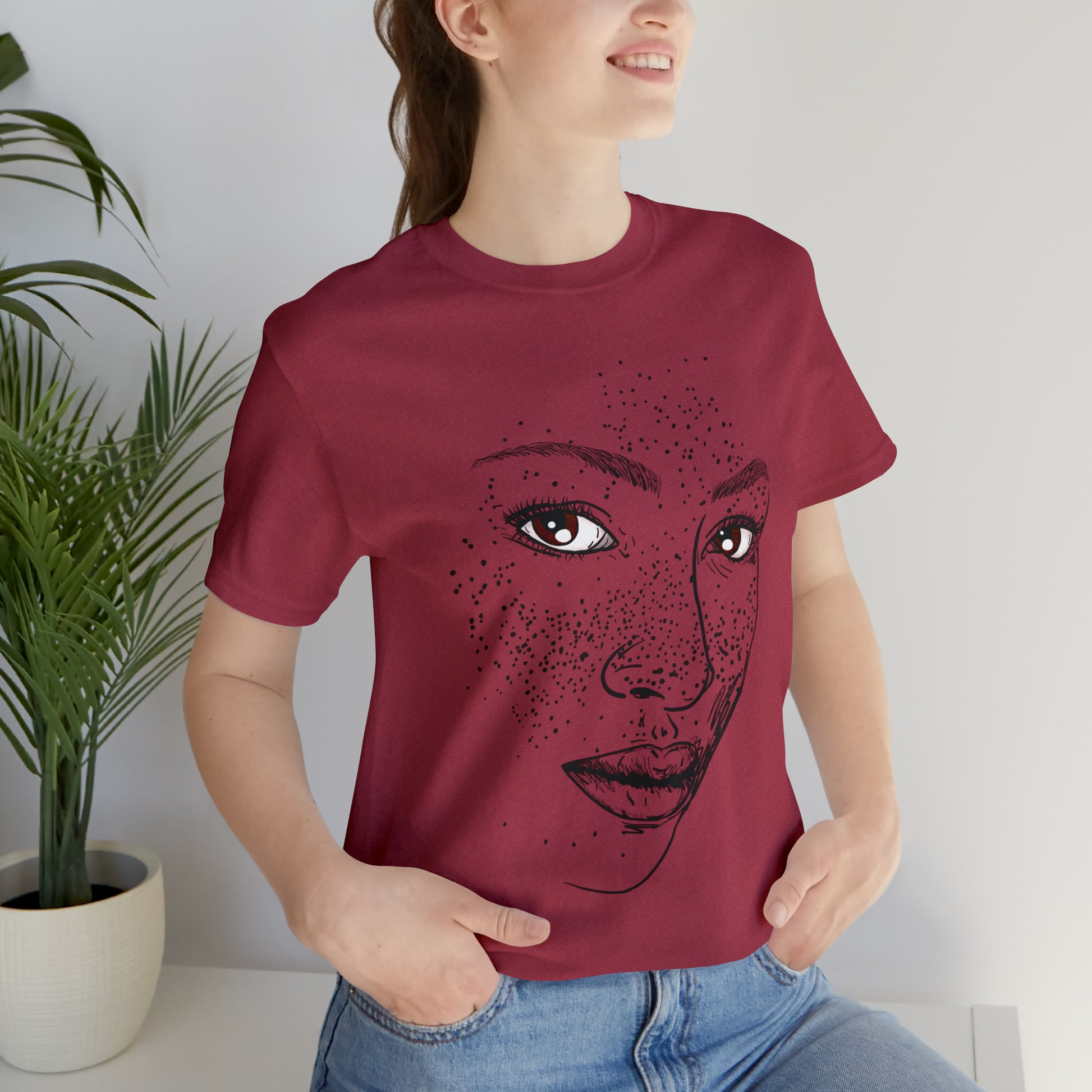 A person wearing a t-shirt with an illustration of a confident and empowered woman. The drawing depicts a woman with a sense of security, strength, and empowerment.