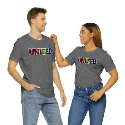 Image of a t-shirt with the word 'UNITED' printed on it in vibrant Pride rainbow colors, symbolizing unity, love, and inclusivity."