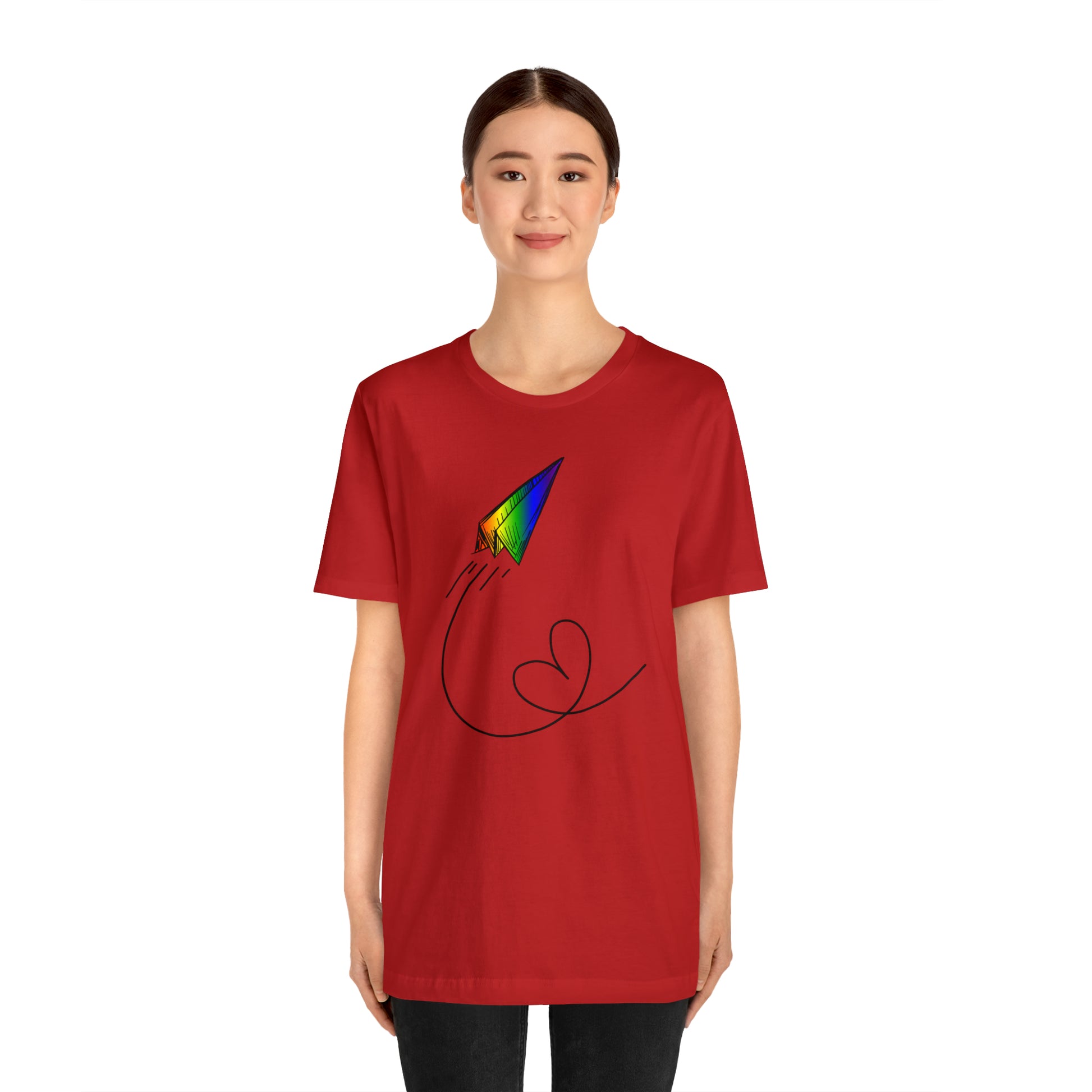 A vibrant t-shirt featuring a paper airplane design in the Pride rainbow colors. The rainbow colors symbolize LGBTQ+ pride and inclusivity.