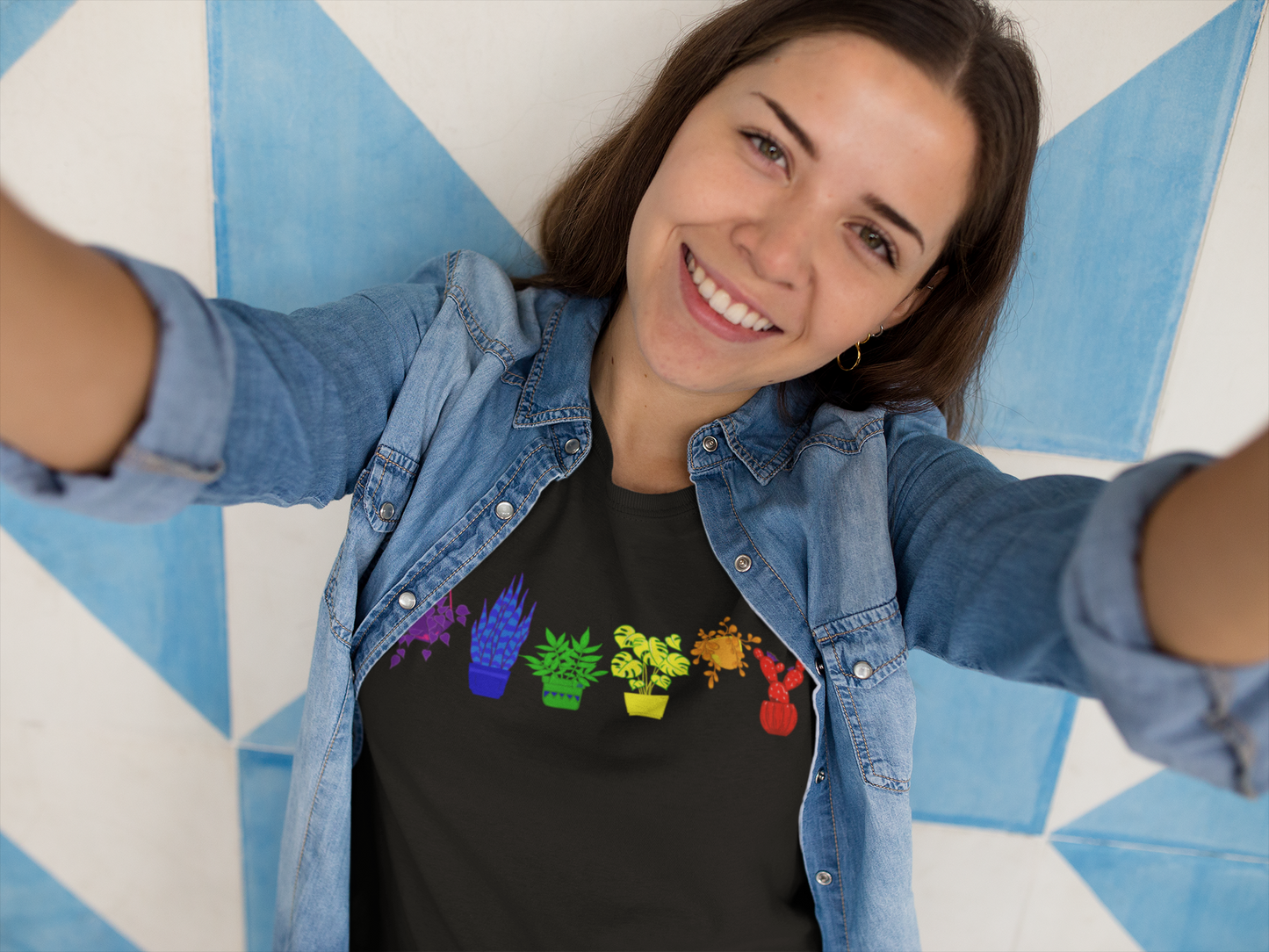 A t-shirt with a vibrant design of plants in the colors of the Pride rainbow.