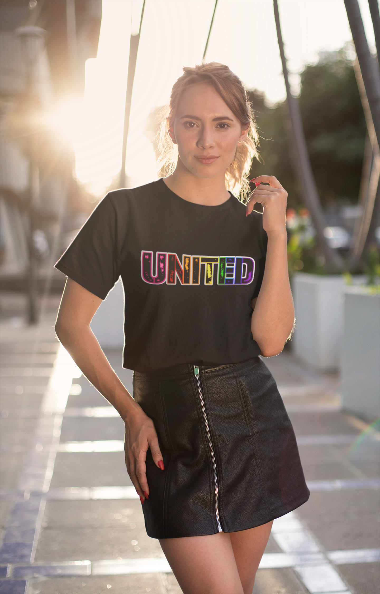 Image of a t-shirt with the word 'UNITED' printed on it in vibrant Pride rainbow colors, symbolizing unity, love, and inclusivity."