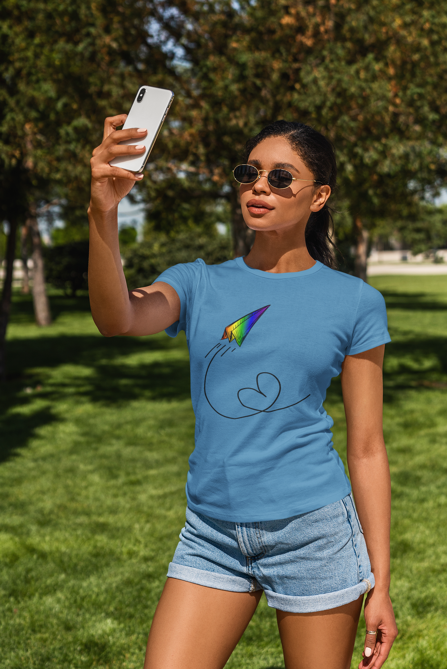 A vibrant t-shirt featuring a paper airplane design in the Pride rainbow colors. The rainbow colors symbolize LGBTQ+ pride and inclusivity.